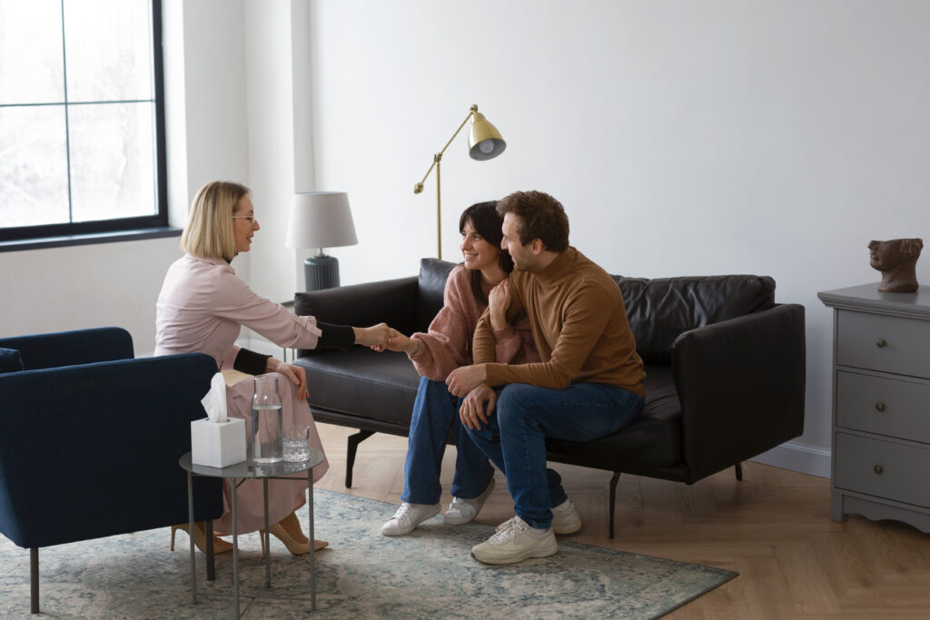 “Couple meeting with a therapist during their first couples therapy session”
