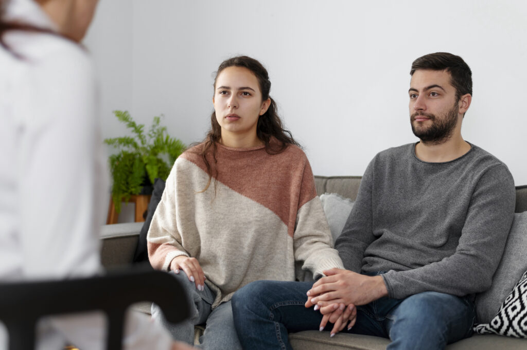Couple discussing relationship concerns with a therapist during a family therapy session