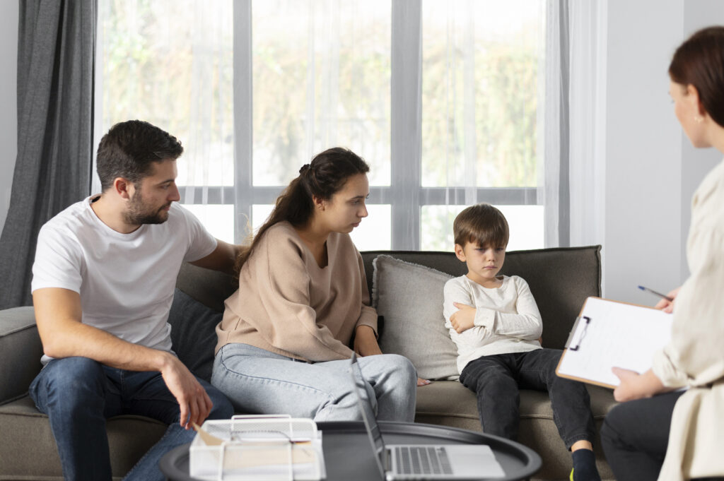Parents and child discussing family concerns with a therapist.