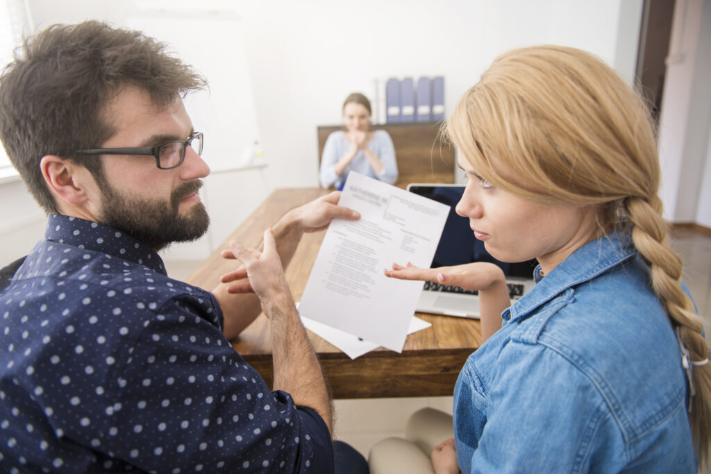 Couple discussing co-parenting conflict during therapy