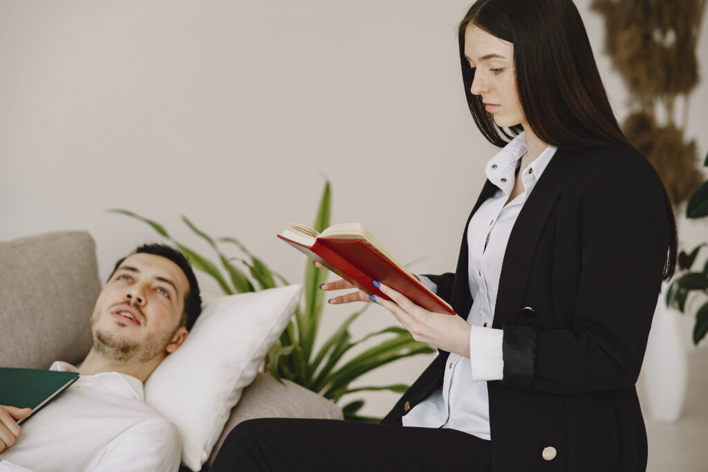 Therapist discussing mental health concerns with a client during a therapy session.